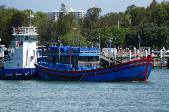 Foreign fishing vessel with sea cucumber cargo and tug