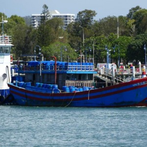 Foreign fishing vessel with sea cucumber cargo and tug